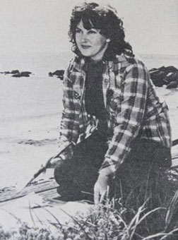 Newspaper-clipping image of Faye Dixon sitting on the beach in Penguin, 1982